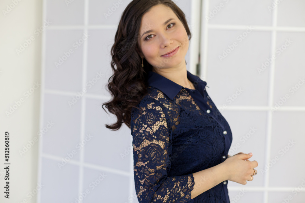 Portrait of a beautiful fashionable Asian woman in a blue dress Portrait of a beautiful fashionable Asian woman in a blue dress