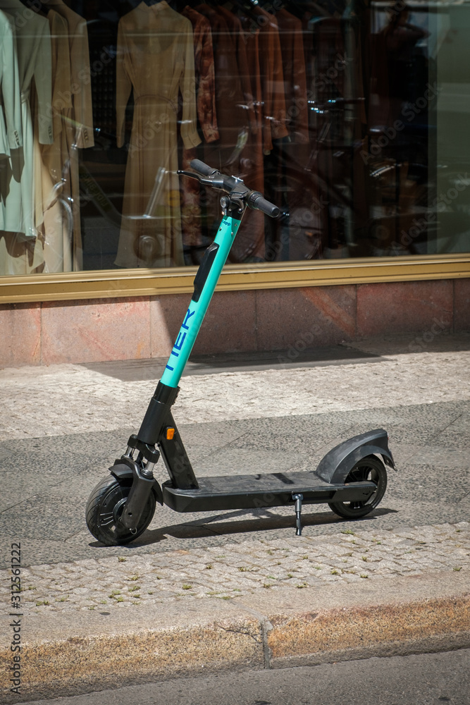 Electric scooter , escooter or e-scooter of the ride sharing company TIER  on sidewalk in - Berlin, Germany - june 2019 foto de Stock | Adobe Stock