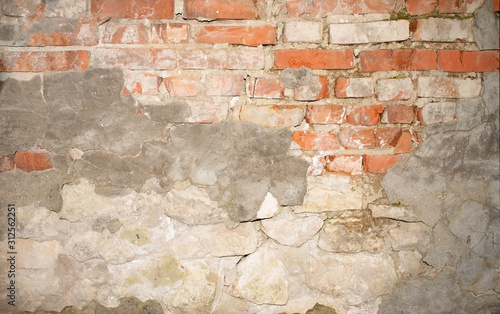 wall of old brick with remnants of plaster