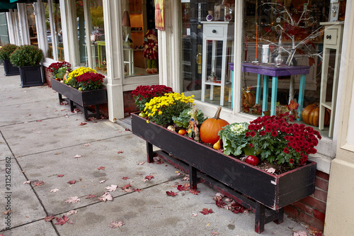 Small shops and restaurants decorated with Fall pumpkins in the historic New England town of Woodstock, Vermont photo
