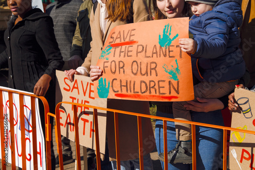 Child with mother with poster of protect environment photo