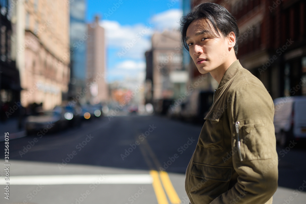 Young man crossing city street Young man crossing city street