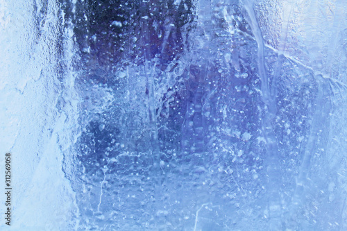 Blue clear transparent ice. Close-up. Background. Texture.