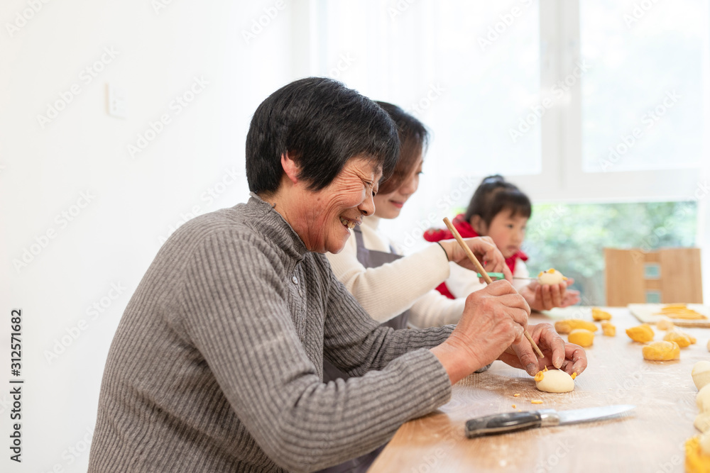 happy asian family making Chinese bread in home happy asian family making Chinese bread in home