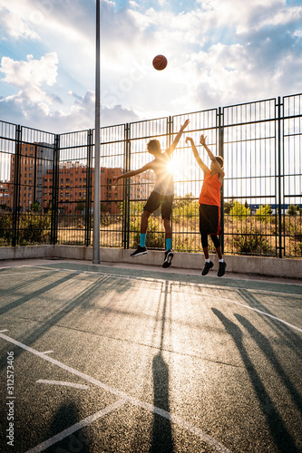 Teenager friends playing basketball