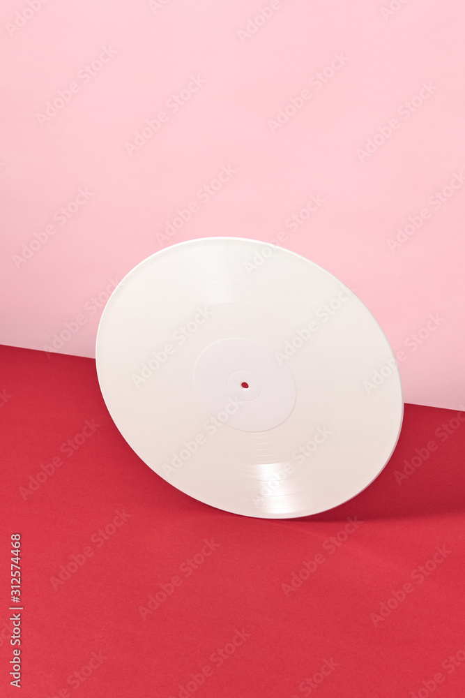 Retro vinyl record white on a duotone red rose background. Retro vinyl record white on a duotone red rose background.