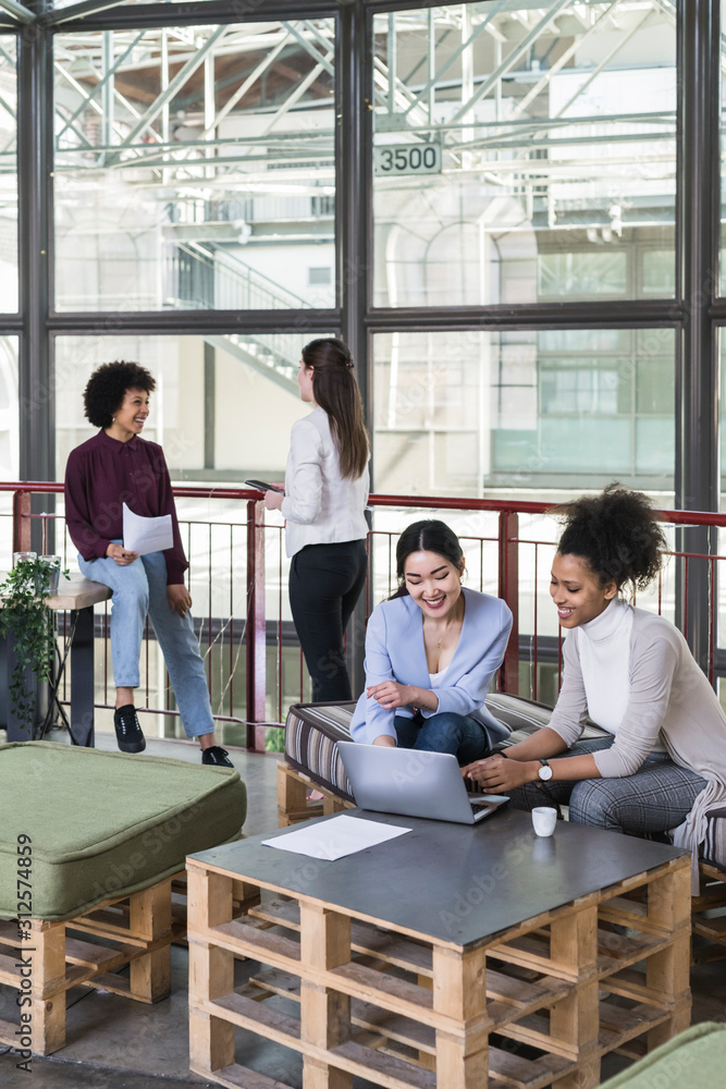 Young businesswomen working in a modern startup in a contemporar Young businesswomen working in a modern startup in a contemporar