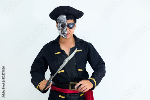 Young adult South East Asian wearing pirate costume with white background..