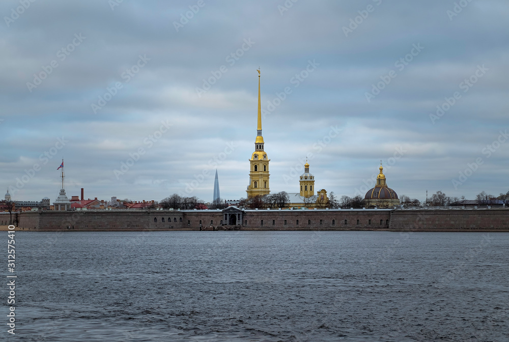 View of the Peter and Paul Fortress across the Neva River against the cloudy sky. December 28 2019. Horizontal orientation.