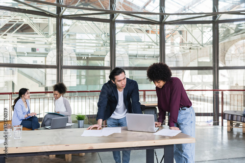 Young businesspeople working in a modern startup in a contempora