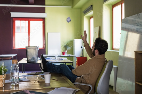 Young businessman playing in a modern office photo