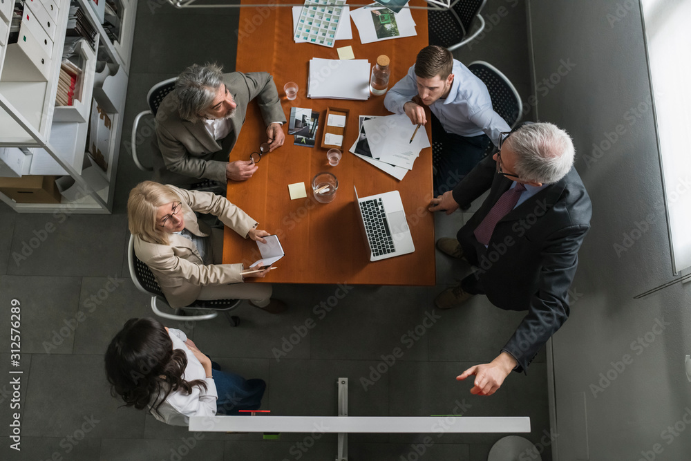© Garage Island Crew/Stocksy - Business people having a meeting © Garage Island Crew/Stocksy - Business people having a meeting