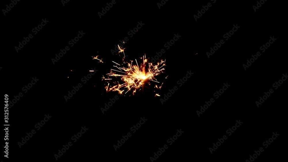 Orange, yellow and red sparkes from a sparkler on a black background. Orange, yellow and red sparkes from a sparkler on a black background.