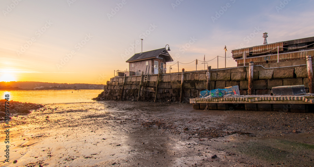 Sunrise at Kittery Point Harbor, Maine. Harbor master shack, wharf, dock, lobster cages. Sunrise at Kittery Point Harbor, Maine. Harbor master shack, wharf, dock, lobster cages.