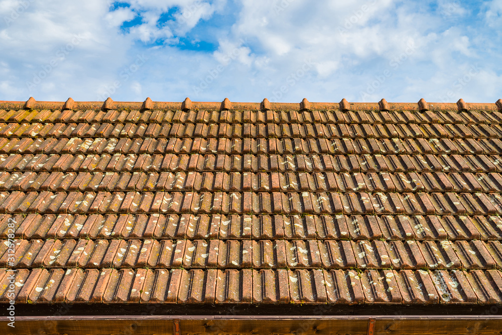 Close up of red old dirty clay roof tiles on sky background. Close up of red old dirty clay roof tiles on sky background.