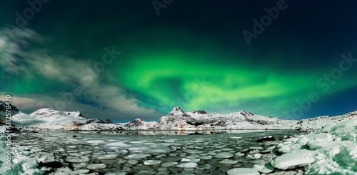Aurora borealis over frozen lake - panorama