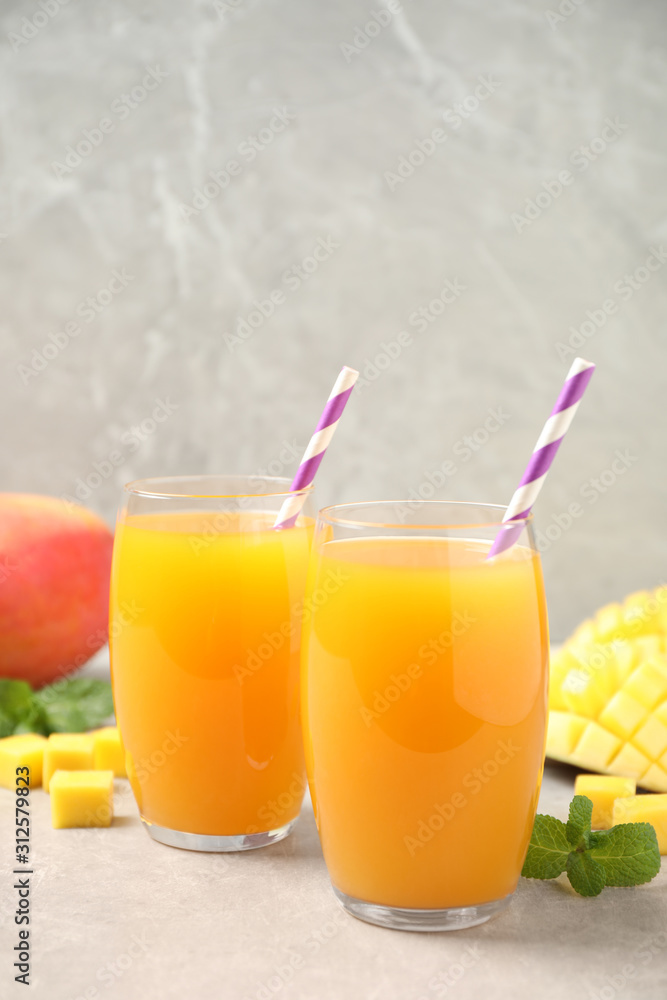 Fototapeta premium Fresh delicious mango drink on light table