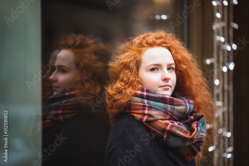 Portrait red hair girl in modern colorful scarf outside © Evgeniya Biriukova