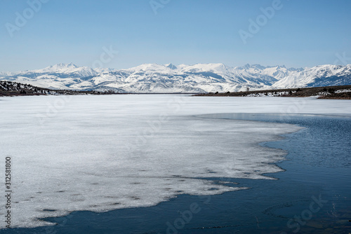 USA, California, Mono County, Bridgeport Reservoir: A thin sheet of ice covers the surface of this frozen lake.