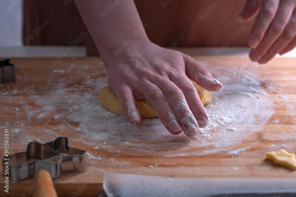 Cut cookies from rolled dough..Cook cuts cookies out of rolled dough.