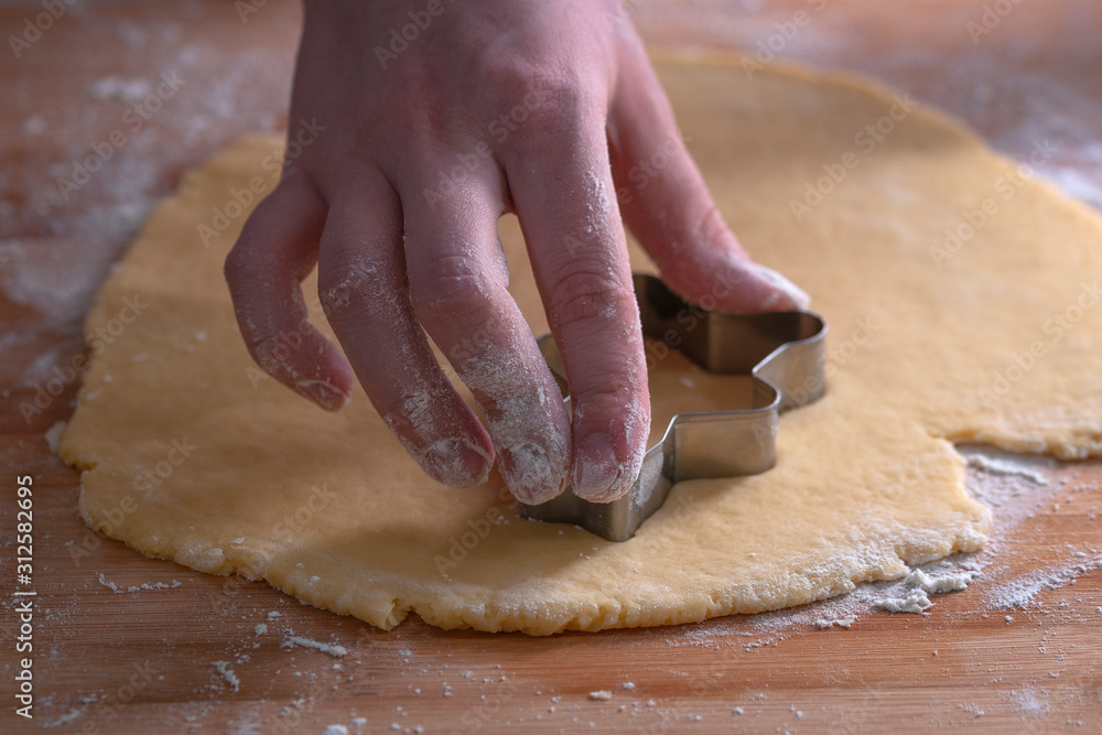 Cut cookies from rolled dough..Cook cuts cookies out of rolled dough. Cut cookies from rolled dough..Cook cuts cookies out of rolled dough.