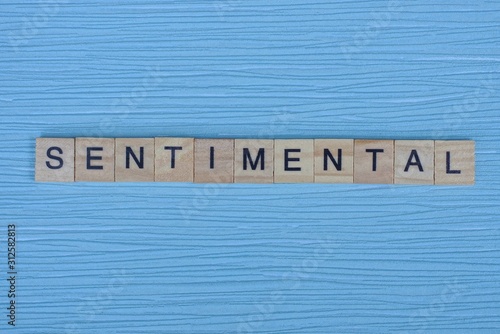 word sentimental from small wooden letters on a blue table