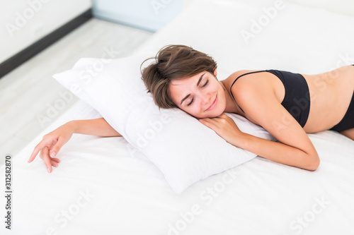 Natural young beautiful woman sleeping in the bed.