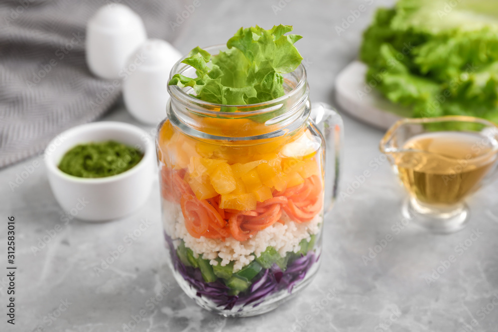 Healthy salad in glass jar on marble table Healthy salad in glass jar on marble table
