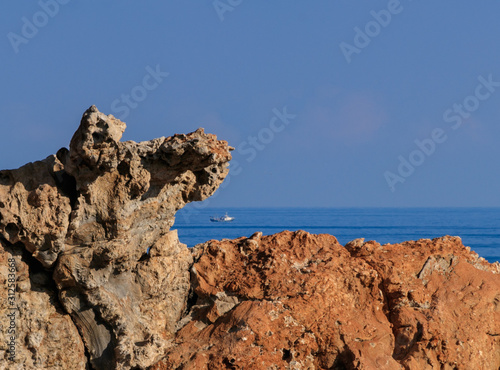 Rocks and fishing ship