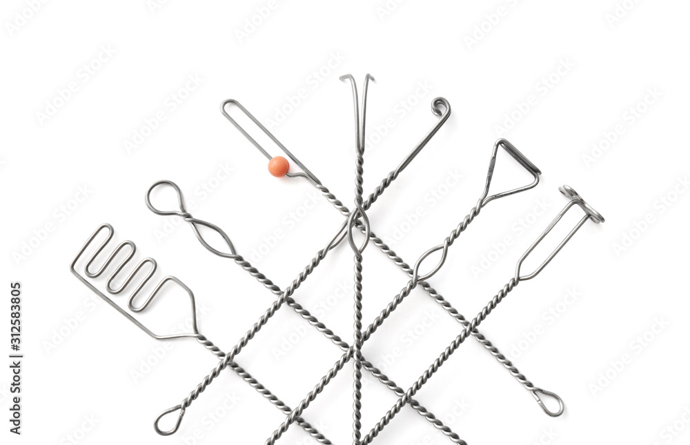 Set of logopedic probes on white background, top view. Speech therapist's tools Set of logopedic probes on white background, top view. Speech therapist's tools