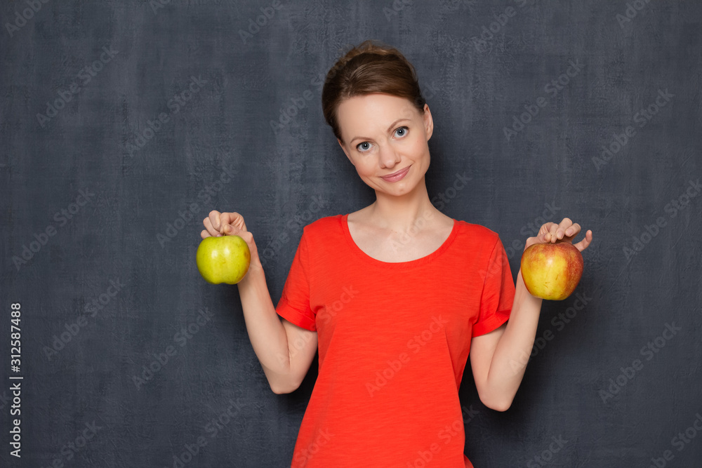 Portrait of happy pretty girl smiling and holding apples in hands Portrait of happy pretty girl smiling and holding apples in hands