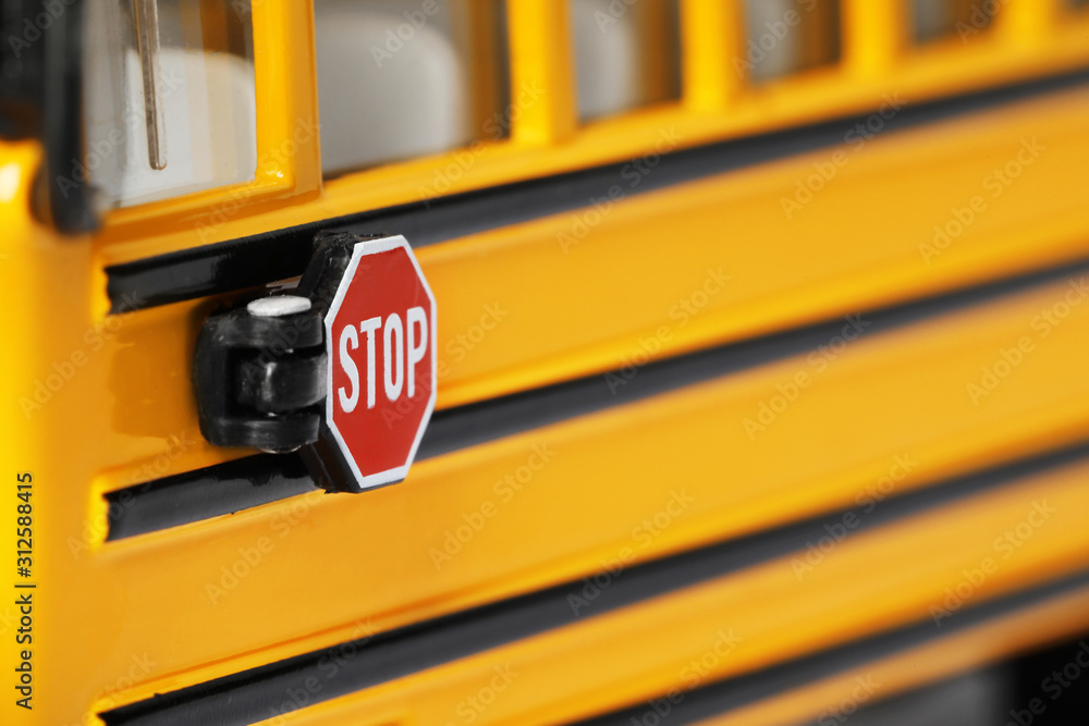 Yellow school bus, focus on stop sign. Transport for students