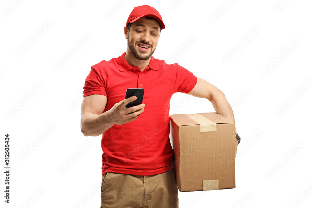 Delivery guy holding a box and looking at a mobile phone Delivery guy holding a box and looking at a mobile phone
