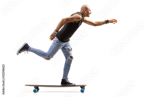 Bald hipster man riding a skateboard