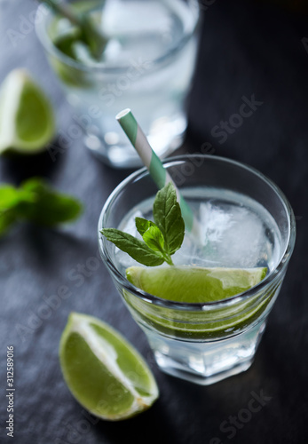 Gin and Tonic on black stone background. Close up.