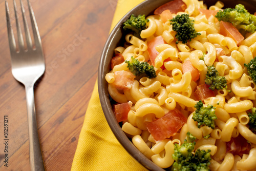 Creamy veggie macarroni salad. Pasta with tomatoes and broccoli. Delicious vegan dish