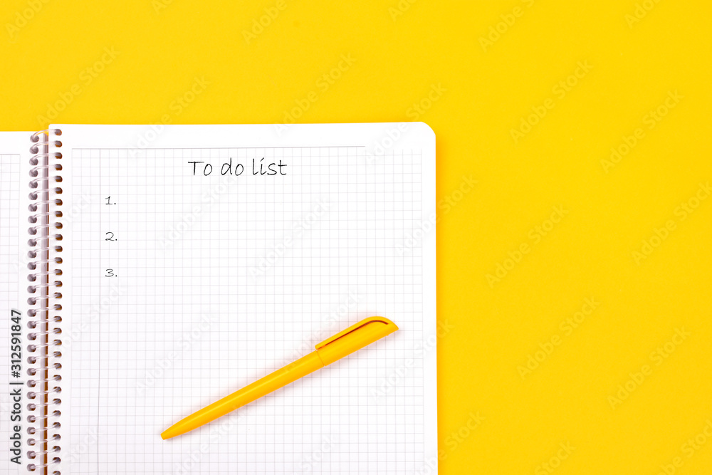 Top view of yellow pen with clean white notebook open with copy space on solid yellow table background for presentation, writer or school education, blogger, novel and friction or brand story concept. Top view of yellow pen with clean white notebook open with copy space on solid yellow table background for presentation, writer or school education, blogger, novel and friction or brand story concept.