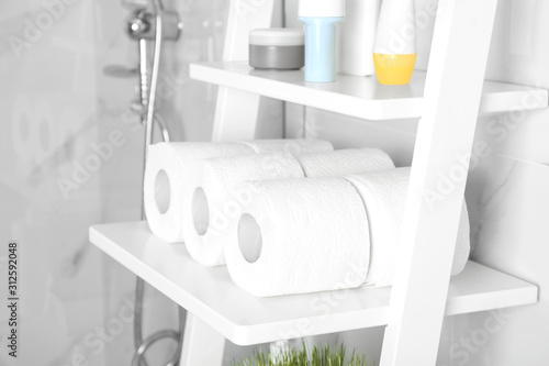 Toilet paper rolls on shelving unit in bathroom © New Africa