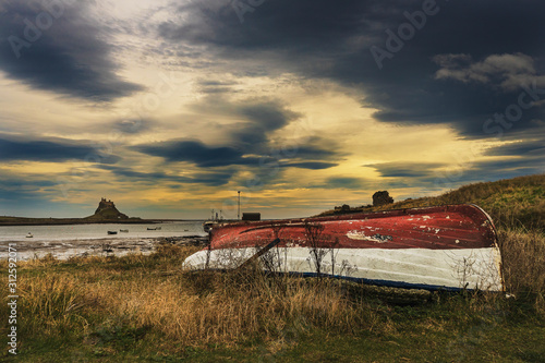 Upturned Boat on Holy Island with Dramatic Sky and Coast Line