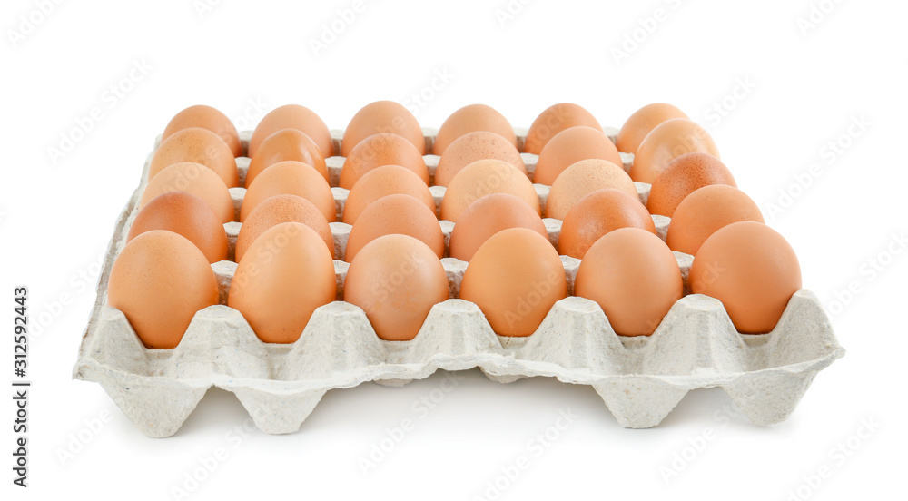 Raw chicken eggs in carton tray isolated on white Raw chicken eggs in carton tray isolated on white