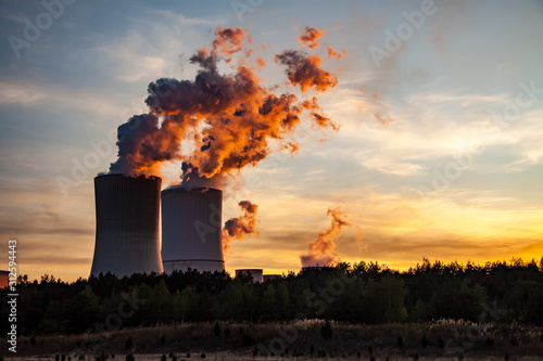 dramatically red smoke from the Boxberg coal-fired power plant at sunset photo