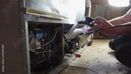 Repairman Cleaning Out Refrigerator