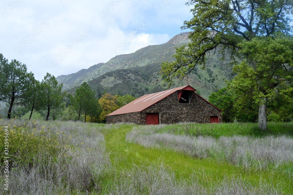 A barn in the Capay Valley of Northern California with a mountain backdrop.