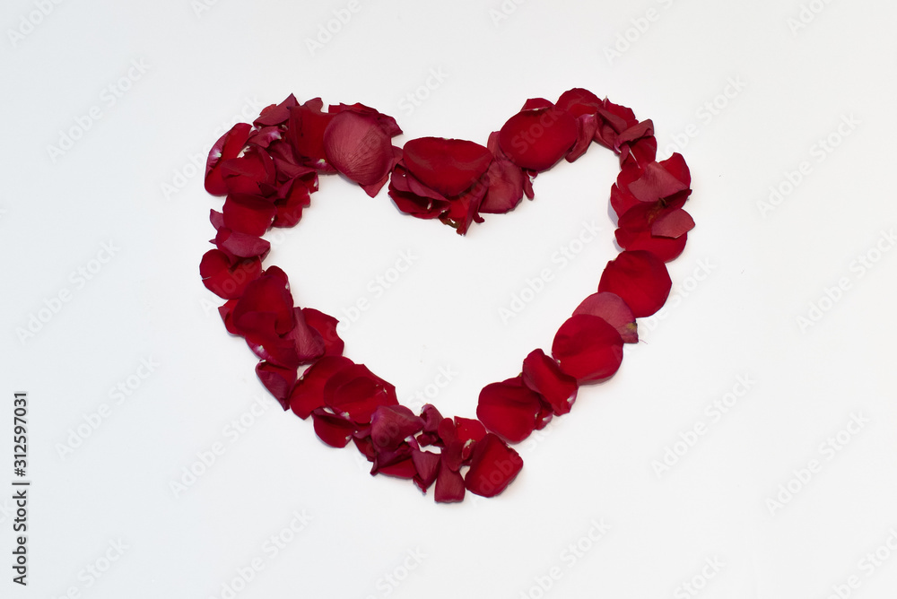 Red heart of rose petals isolated on background