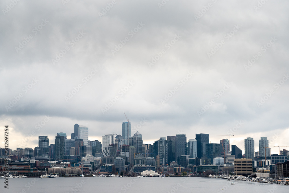 Lakefront Seattle skyline under cloudy sky
