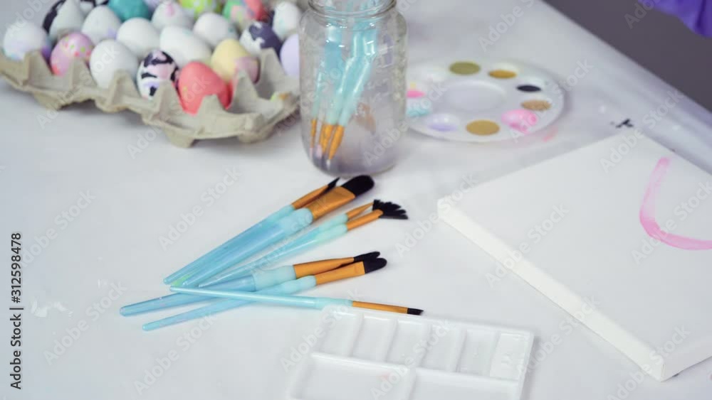 Time lapse. Little girl painting on canvas with acrylic paint. Time lapse. Little girl painting on canvas with acrylic paint.