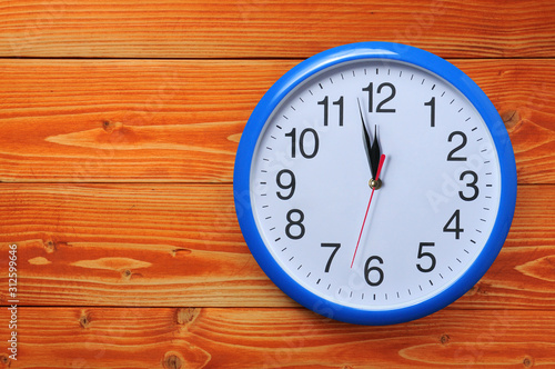 Wallpaper Mural Blue wall clock on a wooden background Torontodigital.ca