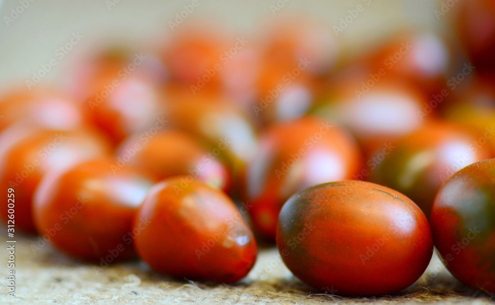 Ripe juicy tomatoes lie on the table, concept of a large crop of vegetables