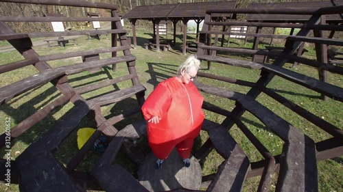 woman in a red chubby outfit in a park