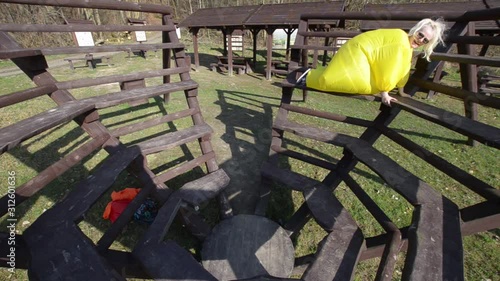 woman in a yellow chubby outfit in a park